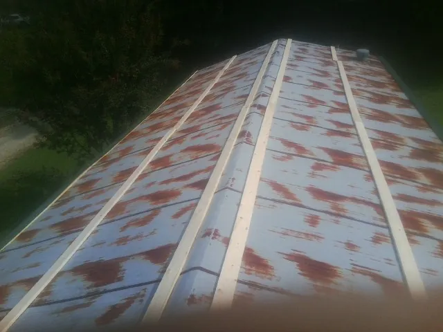 Rusted metal roof panels with new wood purlins before replacement — Storm Damage Roof Repair in Monett by Roofing Brothers